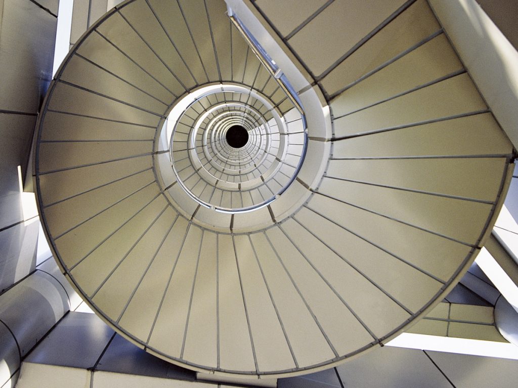 Stairs in a continuous circle of improvement (raising to the next level)